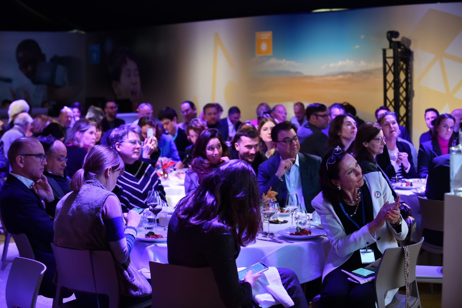 Guests gathered around dinner tables during an InTent at Davos evening event
